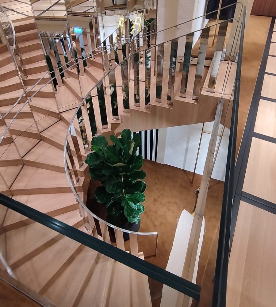 A spiral staircase with Stainless Steel Handrails that are mirror polished