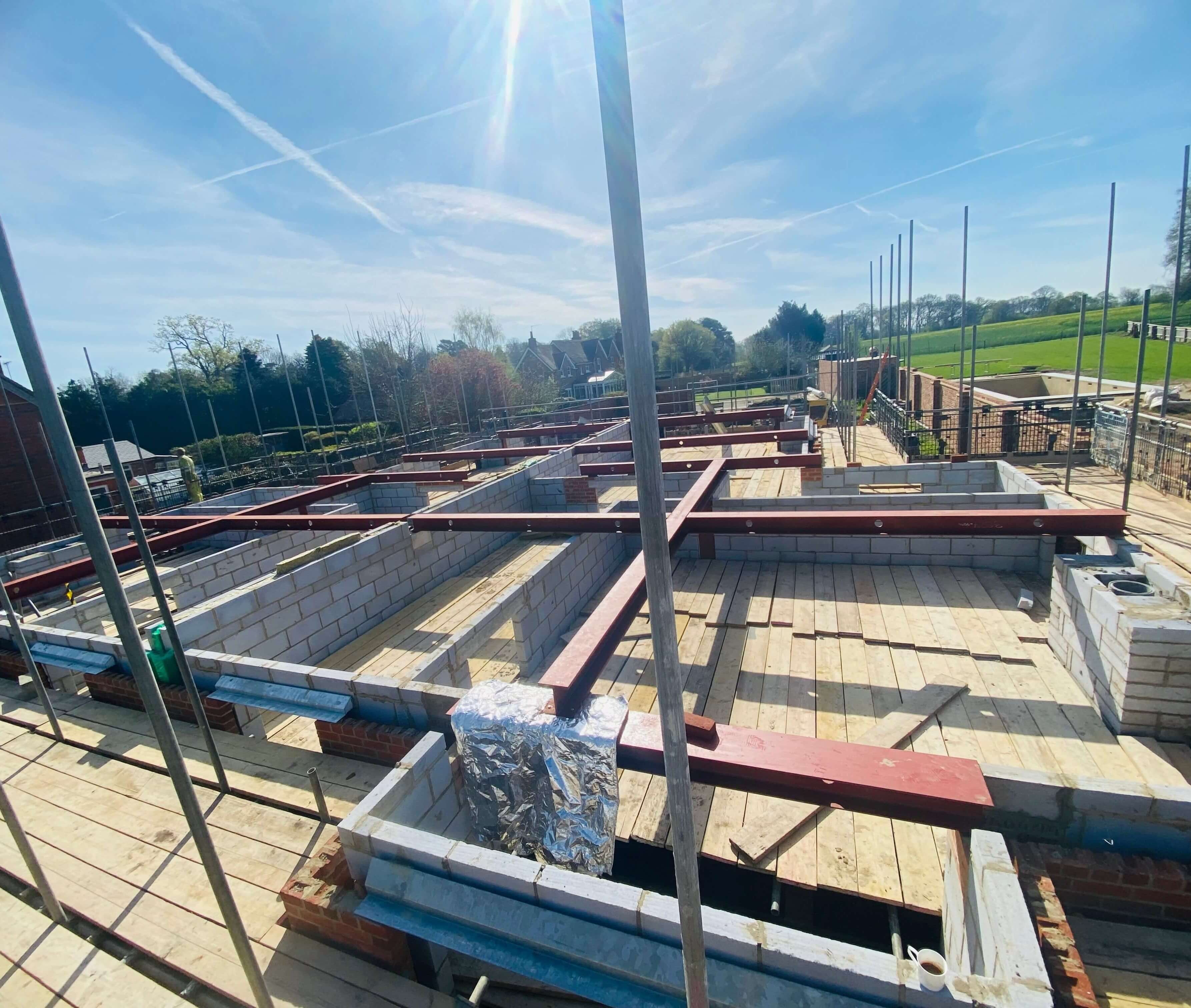 A building under construction with a skeleton of steel beams fabricated by Metcalfe