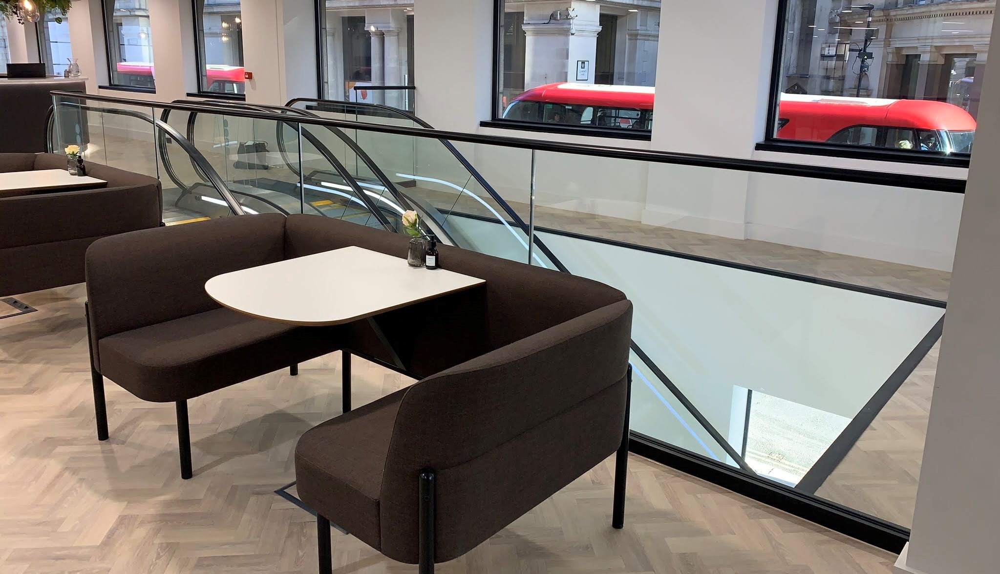framed glass balustrade surrounding escalator
