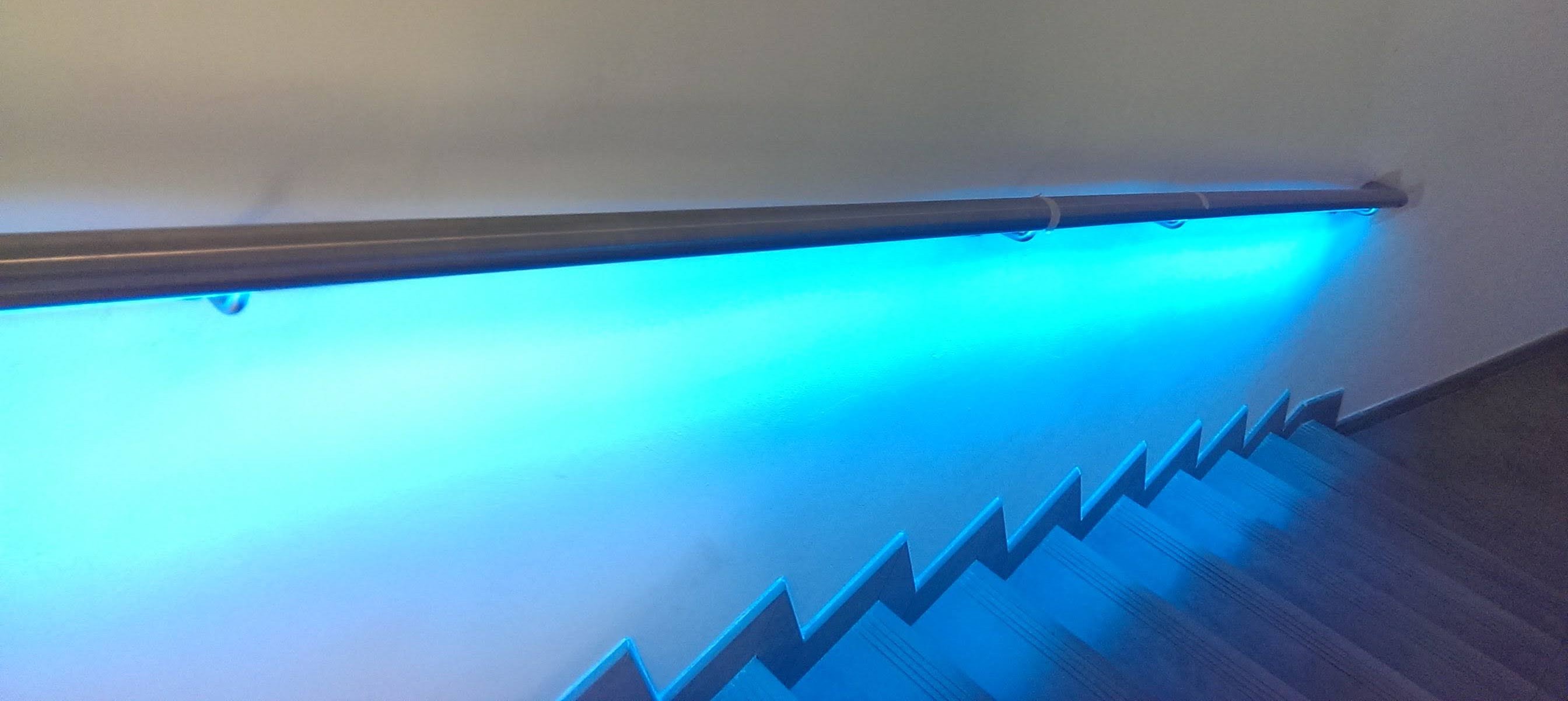 stainless handrail with blue LEDs down internal staircase