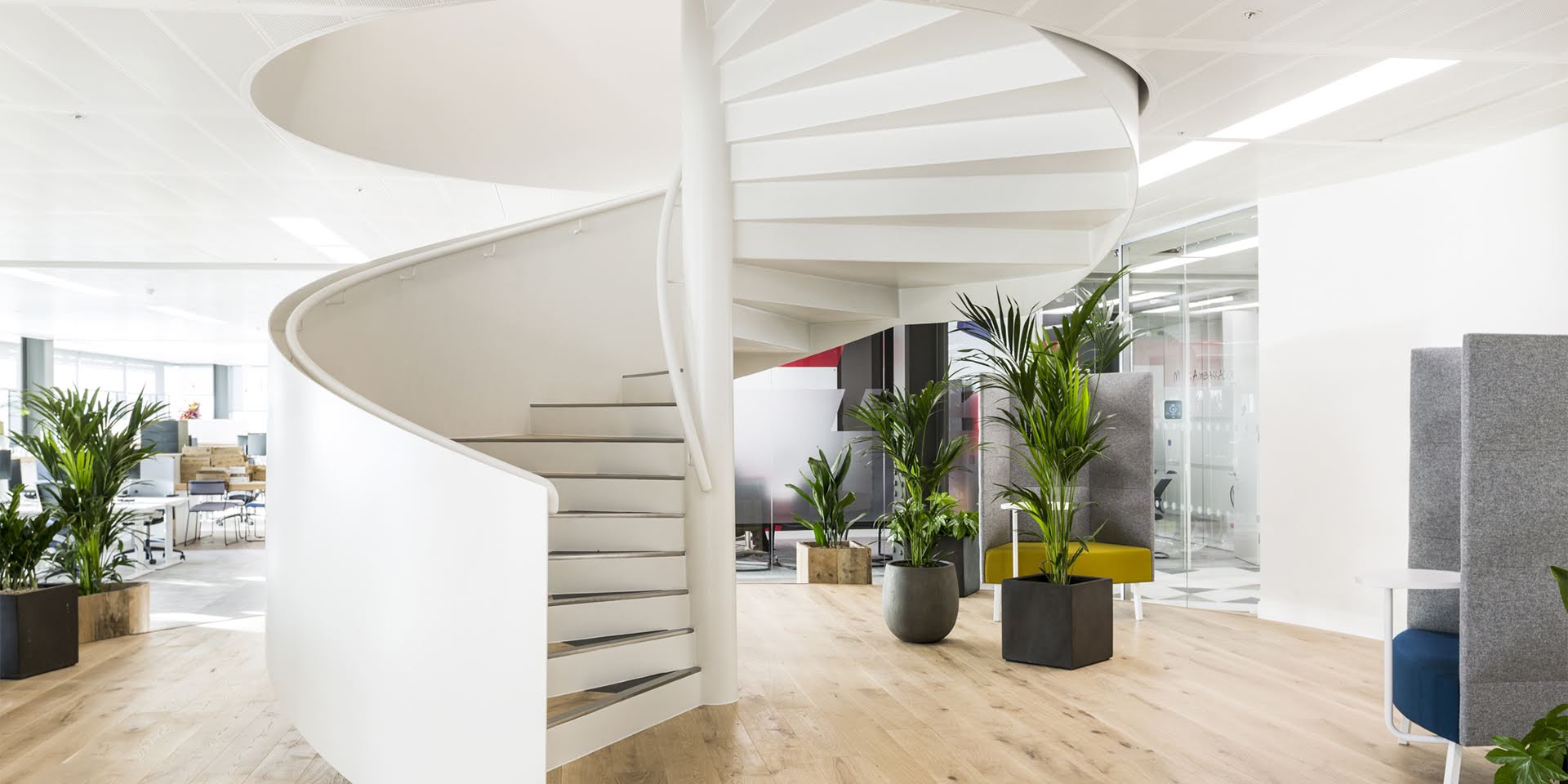 large white internal spiral staircase with panelled balustrade