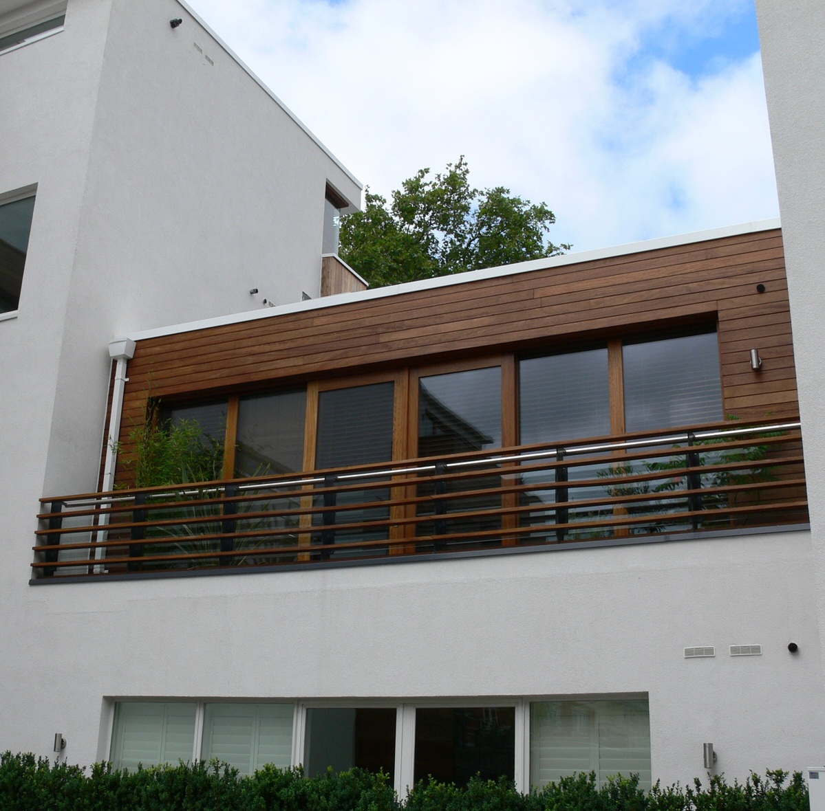 wood and steel balcony at white apartments